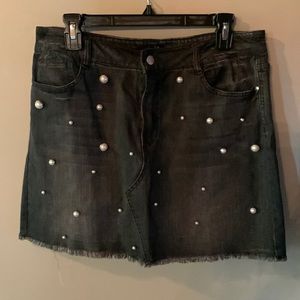 Black denim skirt adorned with Pearl buttons. Like new